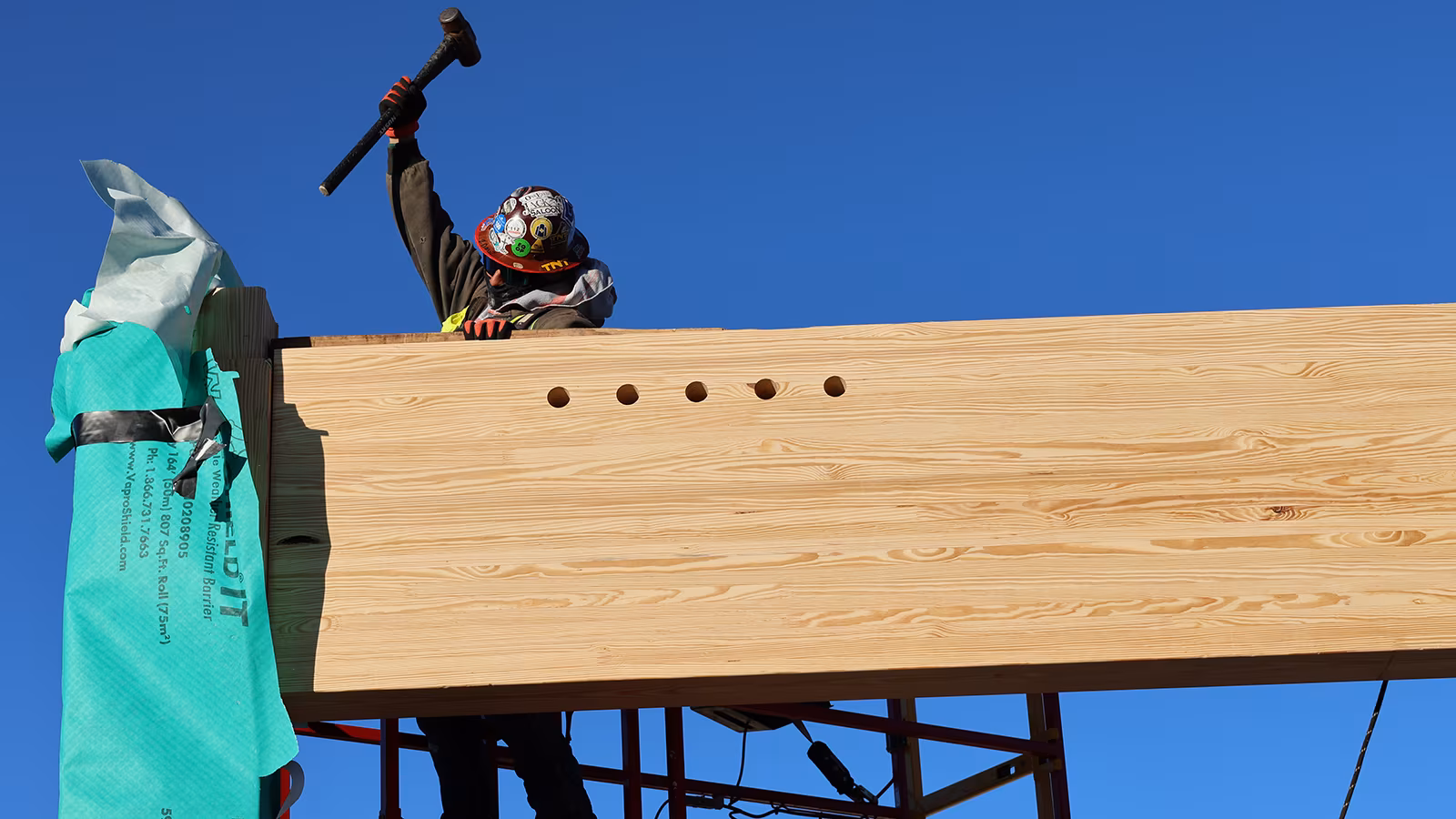 Mass timber beam set into place during construction of the new Guernsey Headquarters